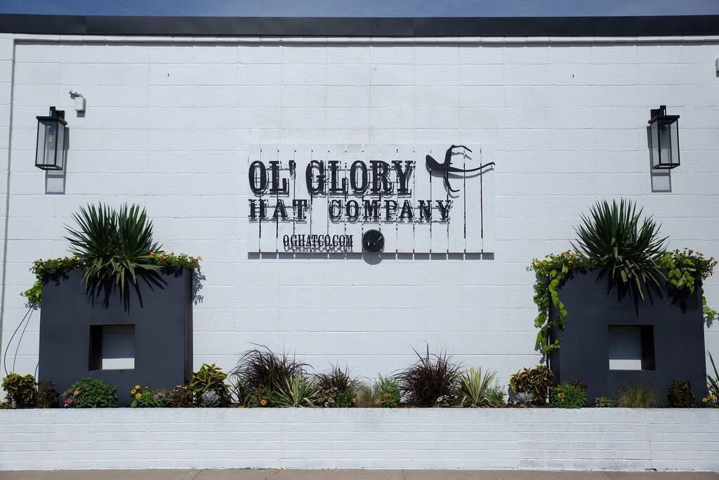 Outdoor facade with signage for Ol' Glory Hat Co. in OKC Stockyards