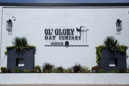 Outdoor facade with signage for Ol' Glory Hat Co. in OKC Stockyards